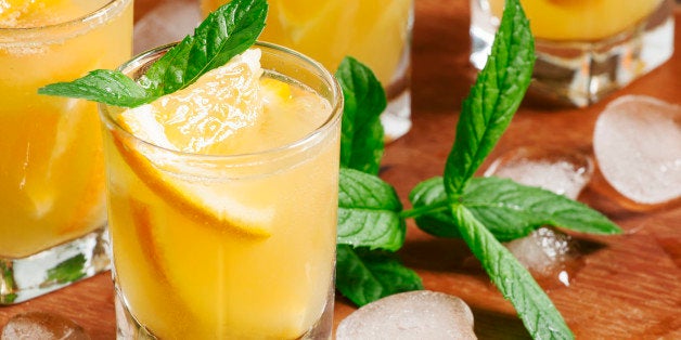 Refreshing cocktail with soda, orange, mint and ice, selective focus