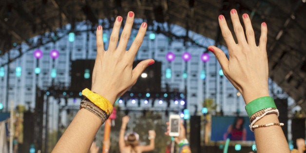 Hands raised concert crowd with copy space. 