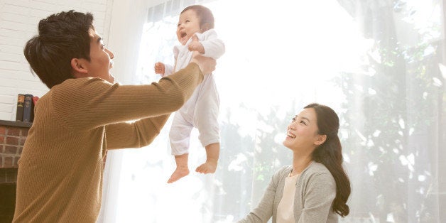 Father lifting baby