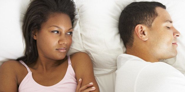 Couple In Bed With Relationship Difficulties Lying Down Angry