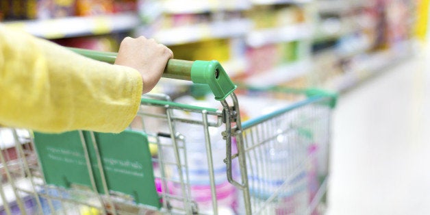 Closeup of woman's hands pushing a shopping cart...