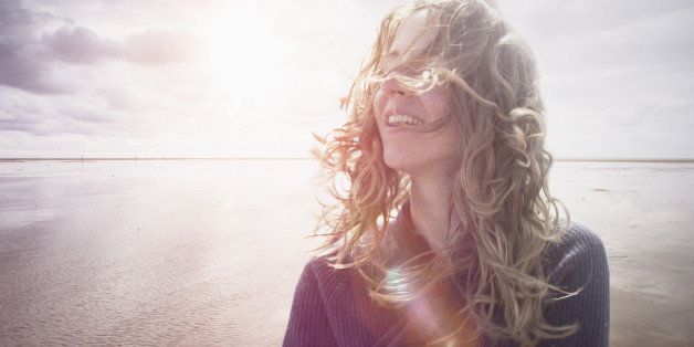 Woman with wind in hair, backlight lens flair
