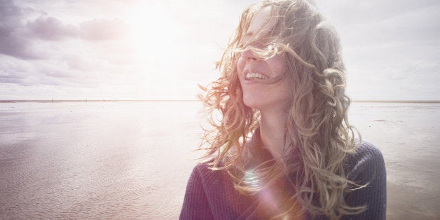 Woman with wind in hair, backlight lens flair