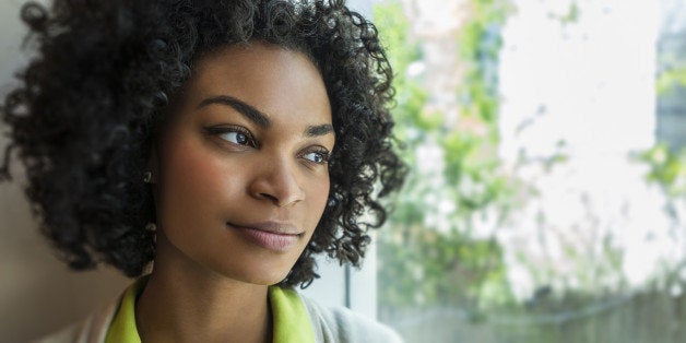 Woman looking thoughtfully out the window