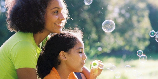 Mother and daughter blowing bubbles