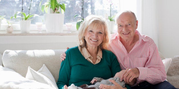 proud grandparents holding newborn grandson