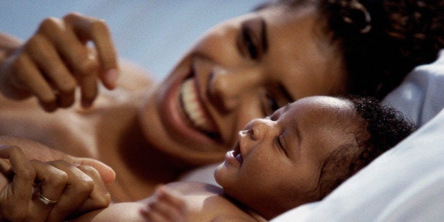 Close-up of a mother lying down with her baby boy