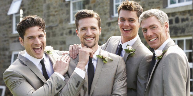 Groom With Best Man And Groomsmen At Wedding Smiling To Camera