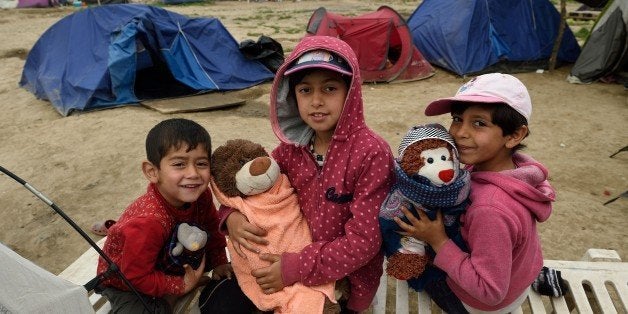 Refugee children pose for a photograph with their toys at the makeshift camp at the Greek-Macedonian border near the village of Idomeni, on April 14, 2016.According to statistics released on April 8 by the International Organization of Migrants (IOM), more than 152,000 people have arrived in Greece by sea from Turkey since January 1, nearly three-quarters of whom were Syrians. / AFP / DANIEL MIHAILESCU (Photo credit should read DANIEL MIHAILESCU/AFP/Getty Images)