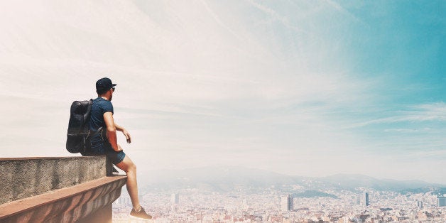 Traveller on a roof looking at the city