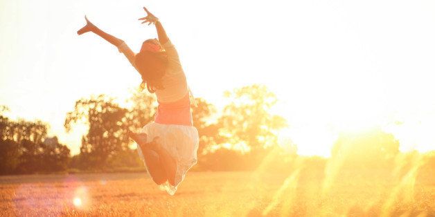 Girl jumping into the sunshine
