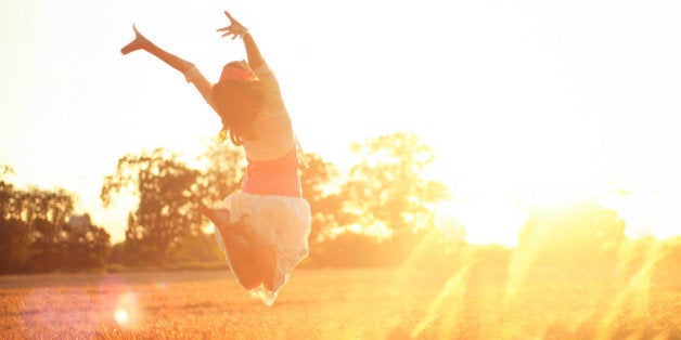 Girl jumping into the sunshine