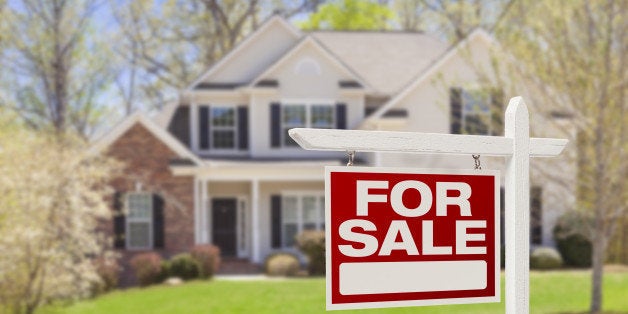 Home For Sale Real Estate Sign and Beautiful New House.
