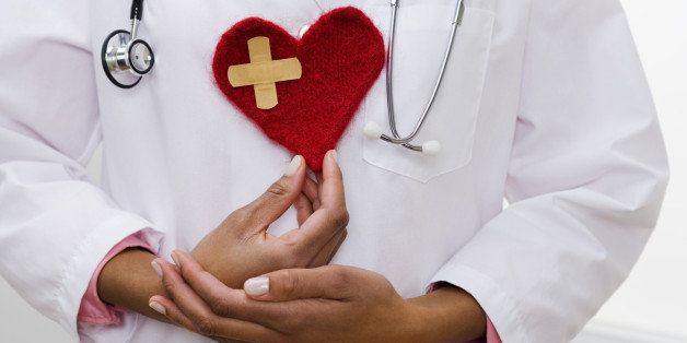 Doctor holding heart with bandage