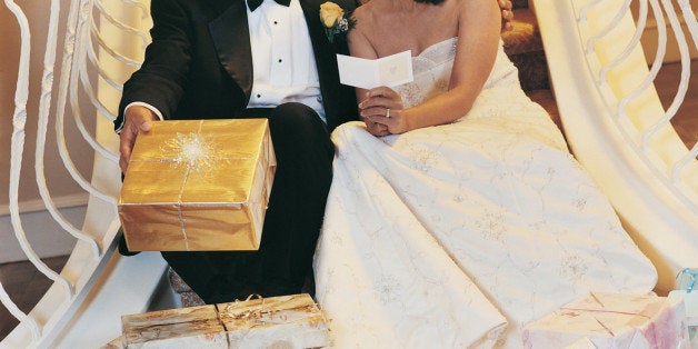 Portrait of Newlyweds Sitting on Stairs With Presents