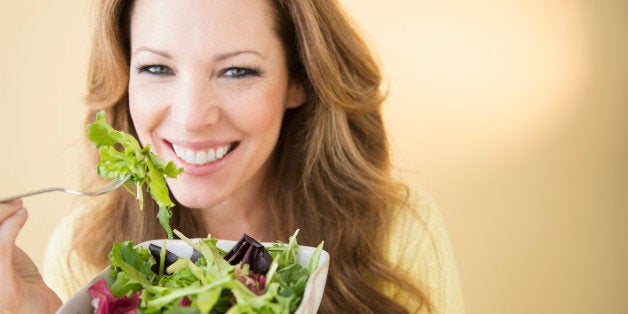 USA, New Jersey, Jersey City, Portrait of woman eating salad