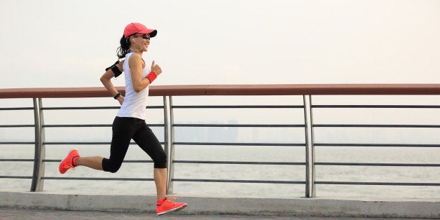 young fitness woman runner running at seaside