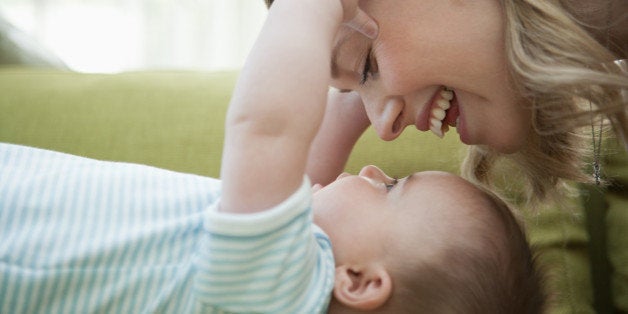 Close up of mother looking down at baby son