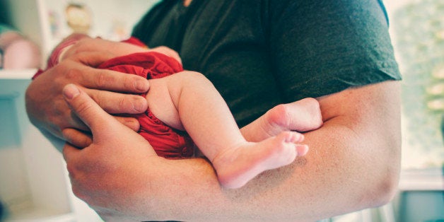 Father holding his newborn baby girl