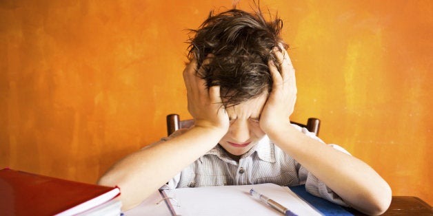 young boy stressed on homework