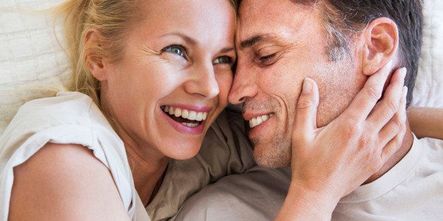 Couple in romantic embrace, woman laughing
