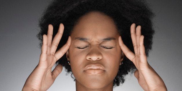 Young woman thinking with hands on face