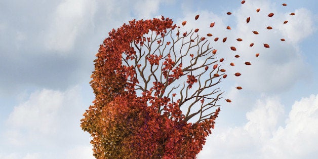 Brain disease with memory loss due to Dementia and Alzheimer's illness with the medical icon of an autumn season color tree in the shape of a human head and brain losing leaves as a concept of intelligence decline.