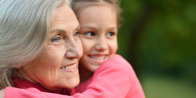Little cute girl with her grandmother in summer park