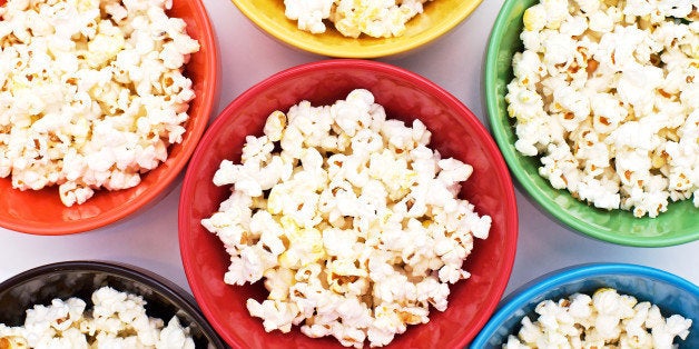 Popcorn in rainbow bowls arranged to fill the frame.