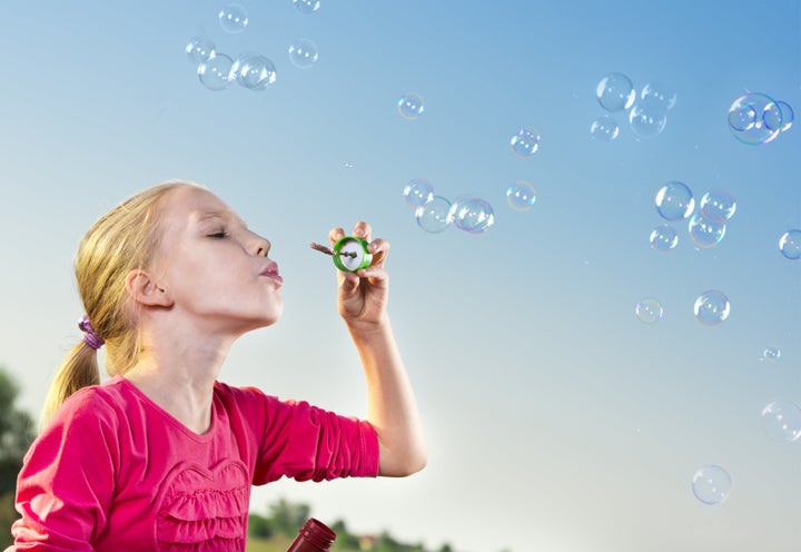 child making soap bubbles...