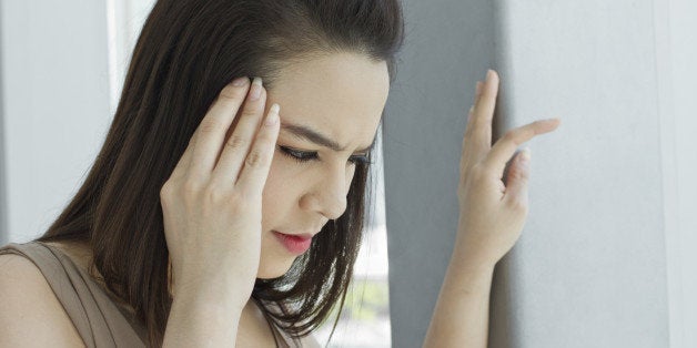 woman with headache, migraine, stress, insomnia, hangover in casual dress