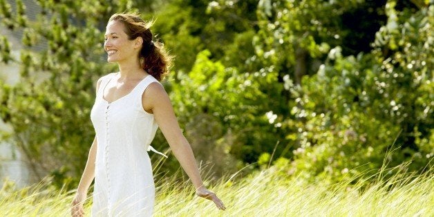 Smiling woman standing in field