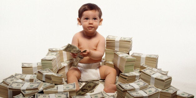 Toddler sitting on stacks of money