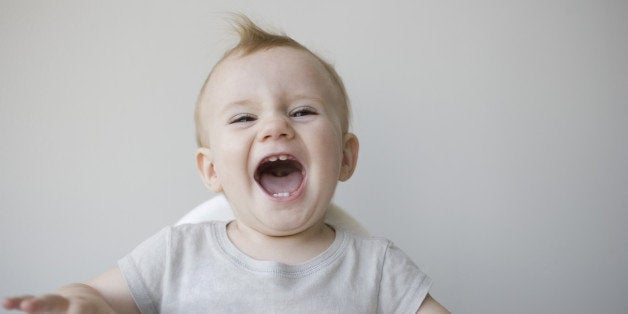 Laughing baby in highchair