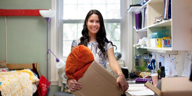 Mixed race woman moving into college dorm room