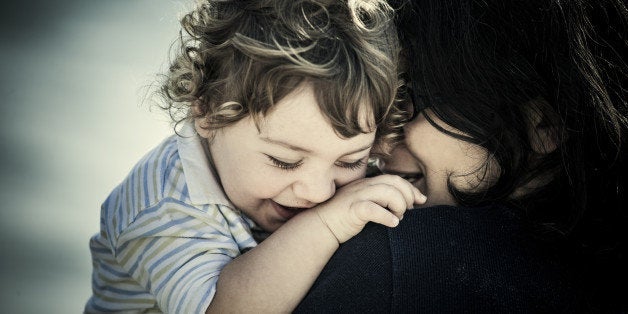 Mom holding smiling son