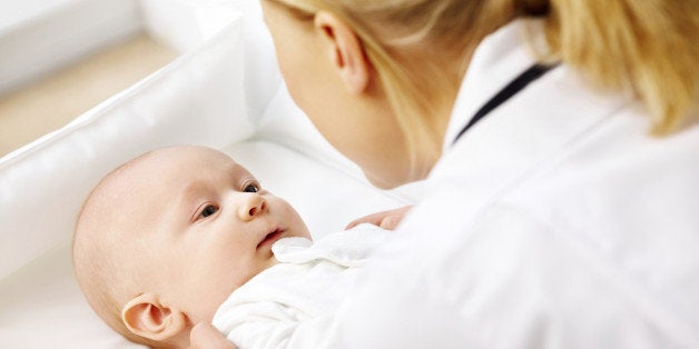 Sweet little baby visiting a hospital being taken care by a nurse