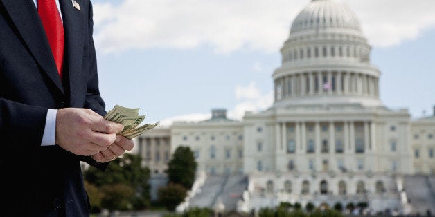 A politician counting money in front of the US Capitol Building