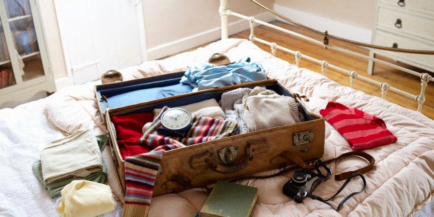 Items in suitcase on bed.