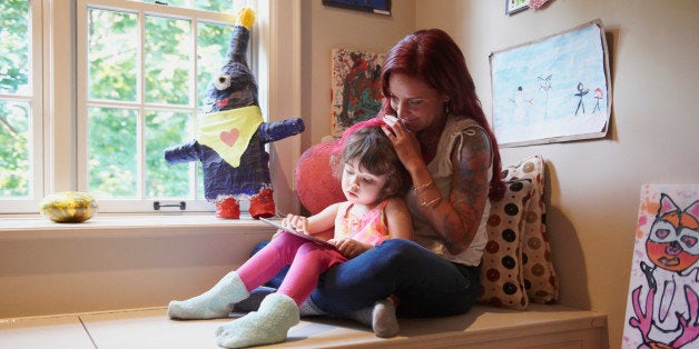 Caucasian mother and daughter using digital tablet