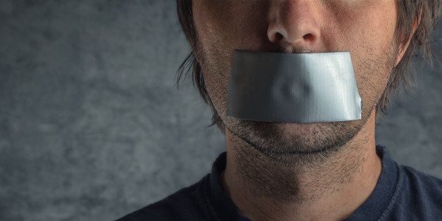 Censorship, adult caucasian man with duct tape on mouth to prevent him from speaking, freedom of speech and expression concept