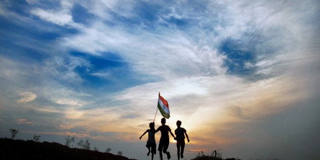 Boys running with indian flag in sunset time.