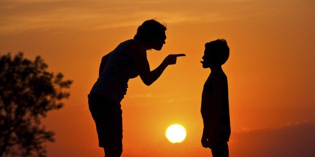 A silhouette of a mother scolding a disrespectful child. Relationship and parenting concept. Discipline. Poor behavior.