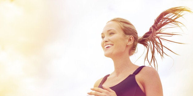 Shot of an attractive blonde woman jogging in the city