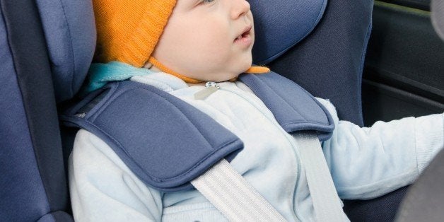 Cute boy sitting in the car seat