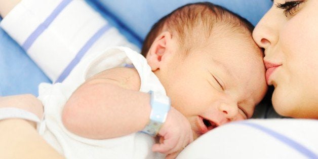 Woman holding her 2 days old newborn baby