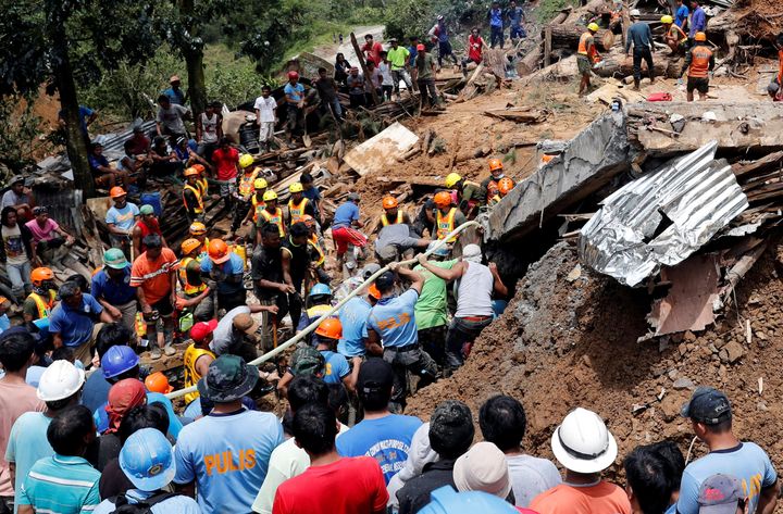 Rescuers search for people trapped in a landslide caused by Typhoon Mangkhut in Itogon, Philippines, on September 17, 2018. 