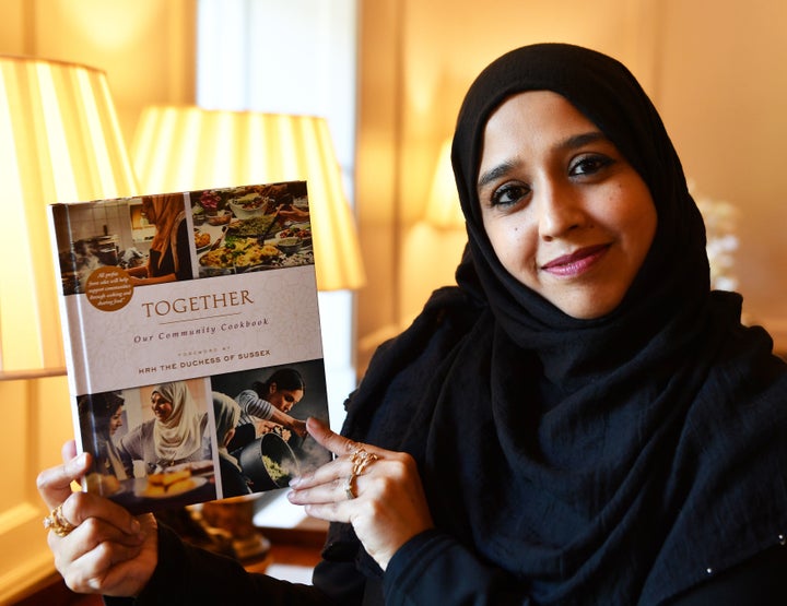 Zahira Ghaswala at Kensington Palace holding a copy of Together, a book that tells how women came together after the Grenfell Tower tragedy to cook for the local community, which has a foreword by the Duchess of Sussex.