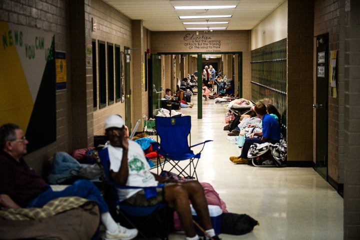 Residents sit in the hallway of a temporary Red Cross shelter at Conway High School ahead of Hurricane Florence in Conway, South Carolina.