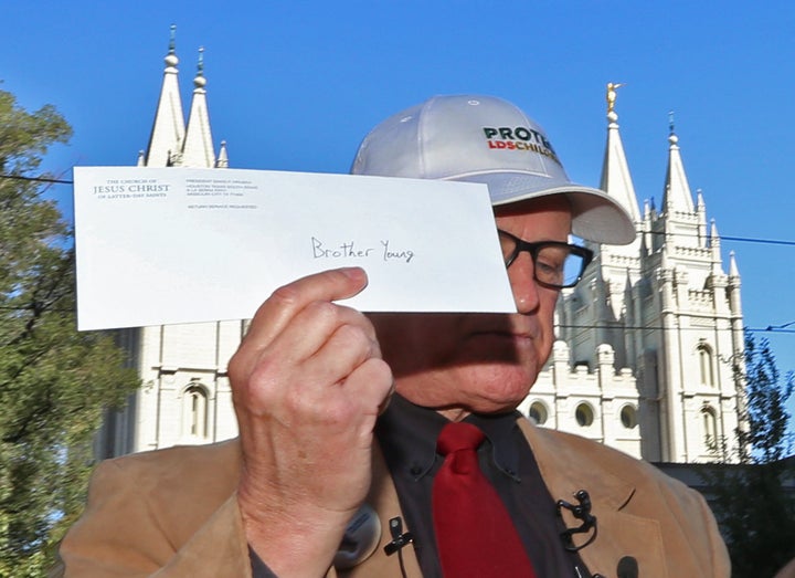 Sam Young holds up a letter that informs him that he has been excommunicated from the Church of Jesus Christ of Latter-Day Sa